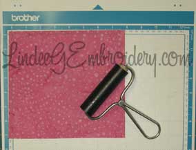LindeeGEmbroidery-Use brayer to smooth fabric to mat